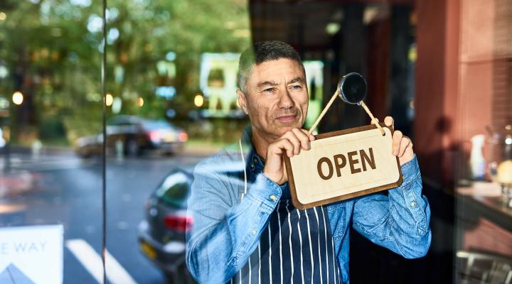 man opening store