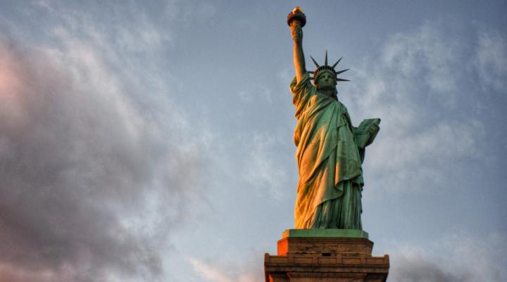 Portrait of Statue of Liberty against a blue gray sky 